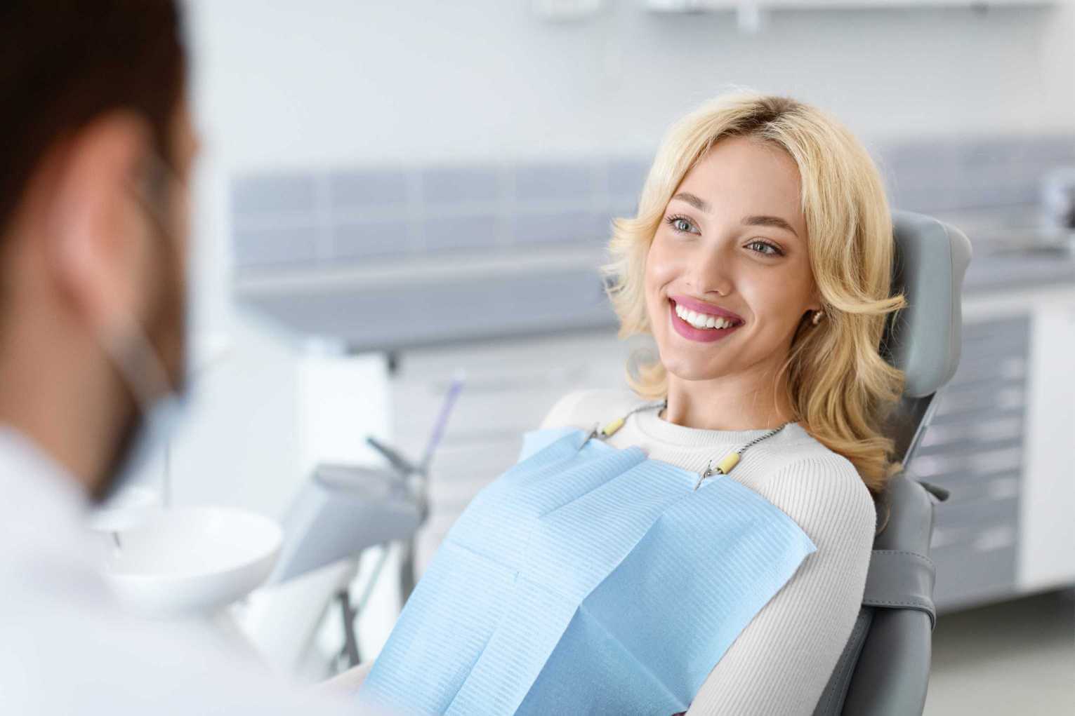 Woman smiling in dentist chair during examination